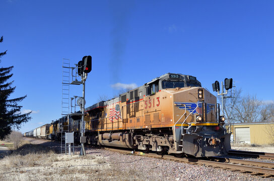 A Union Pacific Railroad freight train splits a pair of railroad signals on a double track mainline in northern Illinois while making its way to Chicago.