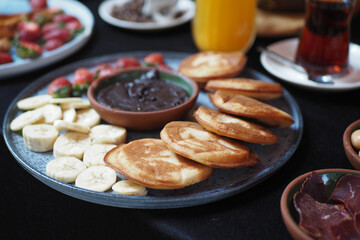pan cake served with banana and strawberry 
