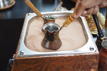 top view of making traditional turkish coffee on sand 