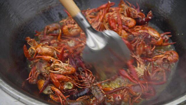 close up of cooking frying spicy crayfish in the pot