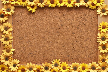 Cork board with yellow flowers sunflowers pasted on it, frame background. Free space for text or greeting  