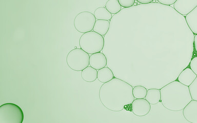 Oil and water serum bubbles of an art image on pale green gradient background. Ideal as app design...