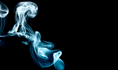 Smoke swirling with blue light effect  isolated on black background. 