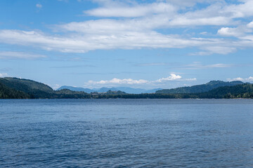 day time on mountain lake with calm water and cloudy sky