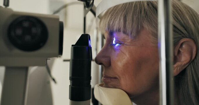 Mature woman, slit lamp or optometry as eye test, medical service or ophthalmology technology. Eyeball, led light or patient in glaucoma, assessment or healthcare lens to diagnose, cornea or myopia