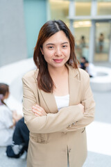 Asian white collar business woman standing outside office city building