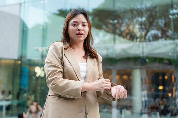 Asian white collar business woman standing outside office city building