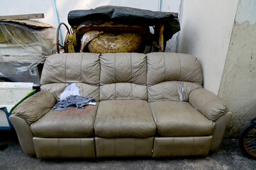 Closeup of Dirty Old sofas left on the side of the road at Thailand, Selective Focus.