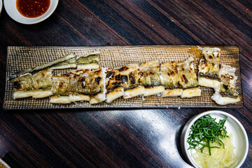 Delicious and healthy grilled eel cooked on an iron plate until yellow.