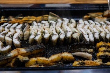 Delicious and healthy grilled eel cooked on an iron plate until yellow.