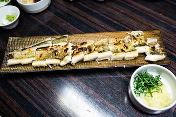 Delicious and healthy grilled eel cooked on an iron plate until yellow.