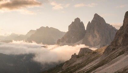 a gorgeous view of rocky peaks surrounded by fog italian alps dolomites south tyrol europe - obrazy, fototapety, plakaty