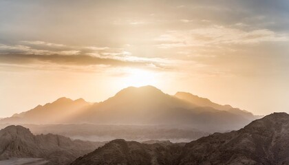 epic sunset landscape sky with big bright sun going behind the mountains in egypt