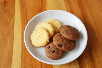 Chocolate chip cookies on a white plate top view