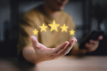 Service rating, satisfaction concept. hand of customer or client holding the stars to complete five...