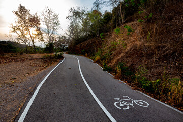 Bicycle lane on the asphalt road in the forest mountain.