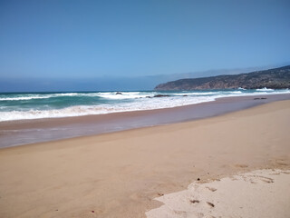 Coast of Portugal. One of the beaches in Cascais with crystal clear water. A great place for water sports - surfing.