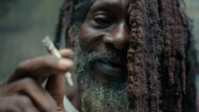 Extreme closeup of Rasta Man while Smoking Marijuana