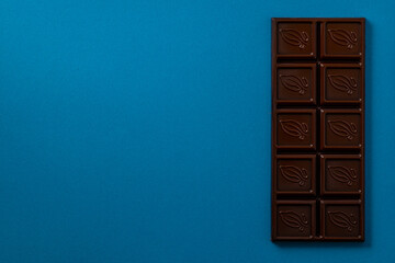 Chocolate bar pieces. Background with chocolate. Sweet food photo concept.