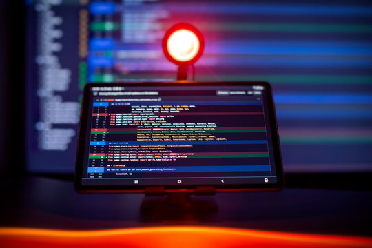 Work from home. Programmer coding code on notebook screen at home.