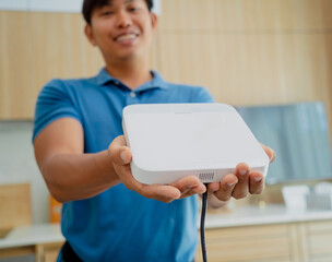 A technician installs a main unit security system in a modern apartment.