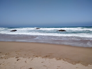 Coast of Portugal. One of the beaches in Cascais with crystal clear water. A great place for water sports - surfing.