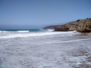 Coast of Portugal. One of the beaches in Cascais with crystal clear water. A great place for water sports - surfing.