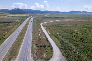  Aerial Drone View of a Highway Running Parallel to a Dry Riverbed in a Rural Area
