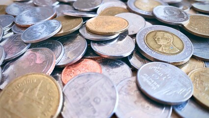 Close-up of a pile of Thai 1 baht silver coins, 2 baht silver coins, 5 baht silver coins, 10 baht silver coins, high resolution background image.