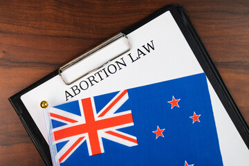 Abortion law in New Zealand, New Zealand flag background, debate over body autonomy, freedom of...