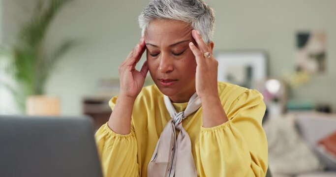 Old woman, laptop of headache of migraine, illness of stress of work, burnout or desk in living room. Mature employee, pain or eyes closed in frustration, anxiety or brain fog as fatigue or failure