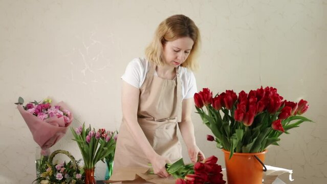 Florist arranging flowers, crafting beautiful bouquets, flower shop ambiance.