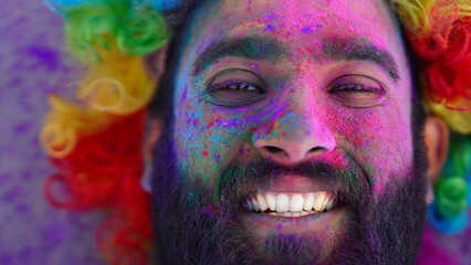 a young boy holi colors painted face closeup