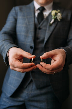 The image features a man in a suit and tie holding a ring 6991.