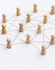 A group of wooden people are connected by strings, forming a network. Concept of interconnectedness and collaboration, as the people are all linked together 