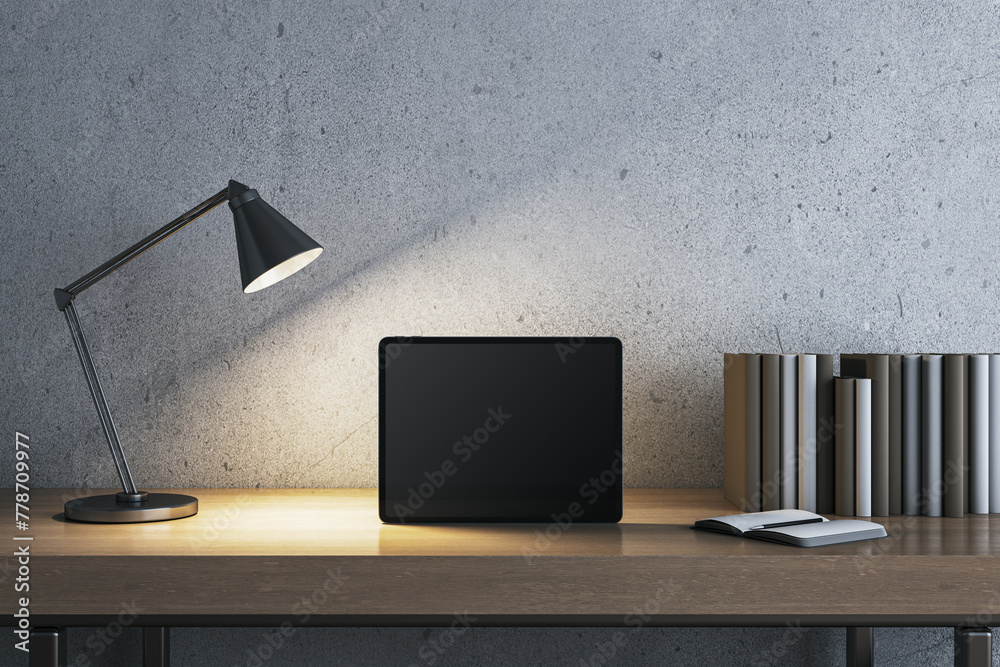 Poster modern concrete workplace with lamp, books and mock up tablet. workspace close up. 3d rendering.