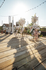 Location for a wedding ceremony on a plank floor. Evening sunset.