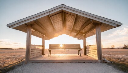 a wooden covered shelter with two benches and a window the bench is empty the shelter is on a white...