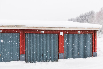 Snow-Covered Garages Next to Forest in Mölndal, Sweden