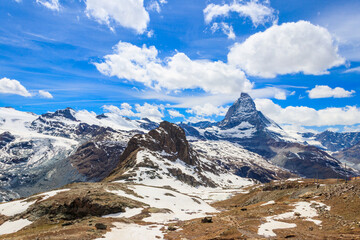 Scenic view on snowy Matterhorn mountain peak in sunny day with blue sky in Switzerland. Beautiful nature background of Swiss Alps covered with snow. Famous travel destination