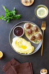Swedish meatballs in cream sauce, potatoes and lingonberry sauce. Swedish cuisine. Recipe.