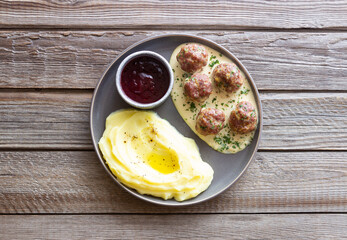 Swedish meatballs in cream sauce, potatoes and lingonberry sauce. Swedish cuisine. Recipe.