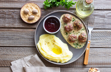 Swedish meatballs in cream sauce, potatoes and lingonberry sauce. Swedish cuisine. Recipe.