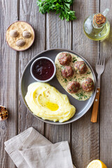 Swedish meatballs in cream sauce, potatoes and lingonberry sauce. Swedish cuisine. Recipe.
