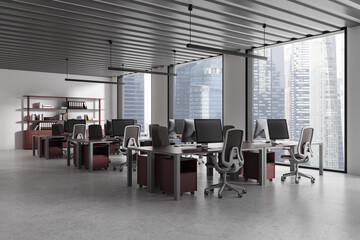 Fototapeta premium Gray and red hot desk office corner with row of computer desks