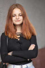 Fototapeta premium Portrait of a young beautiful red-haired girl in a summer park.