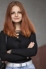 Fototapeta premium Portrait of a young beautiful red-haired girl in a summer park.