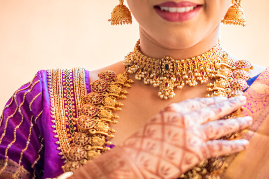 Beautiful gold necklace Indian bridal getting ready her wedding day, Indian bride with a gold necklace and smile on face.