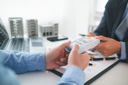 Real estate brokers are bribing government officials with cash issue construction permits in areas where high rise buildings are prohibited. Concept bribing government officials to facilitate business