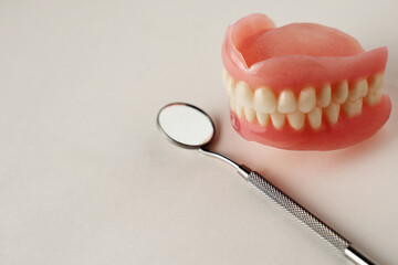Dentures and dentist tools on a white background with copy space - 778760325
